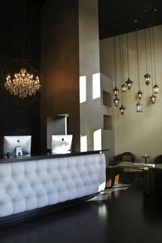 a white reception table with lights hanging from the ceiling