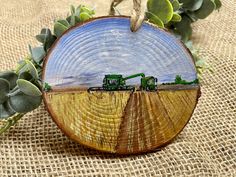 a wooden ornament with two tractors in the middle of a field on burlock