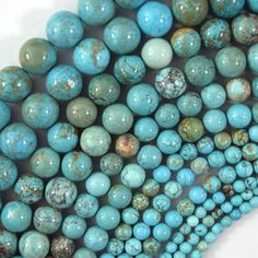 several blue and green beads are stacked together