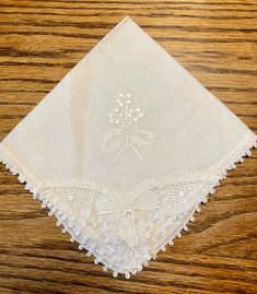 "Pristine vintage white linen handkerchief (never used), embroidered white-on-white and edged in lace; handmade in Brazil probably in the 1990s. Approximately 10\" square. Perfect for a bride or another member of a wedding or confirmation party to carry." Vintage Cream Handkerchiefs As Gift, Vintage Cream Handkerchief As Gift, Vintage Cream Handkerchiefs Gift, Vintage Cream Embroidered Handkerchiefs, Vintage Handmade Wedding Handkerchiefs, Vintage White Handkerchiefs With Lace Trim, Vintage Cream Handkerchiefs With Lace Trim, Vintage Lace Trim Handkerchiefs As Gift, Vintage Handkerchiefs With Lace Trim For Gift