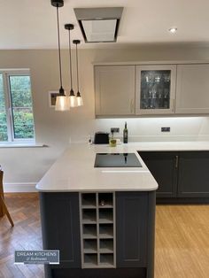 Kitchen breakfast bar with a built in wine cooler. Kitchen Sink Breakfast Bar, Kitchen With Hob On Island, Breakfast Bar With Wine Fridge, Kitchen Ideas Breakfast Bar, Kitchen Diner Island, Breakfast Bar With Stove, Kitchen Peninsula With Hob, Breakfast Bar With Hob