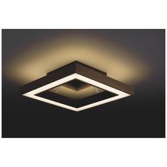 a square light fixture in the middle of a dark room