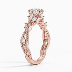 a rose gold engagement ring with an oval diamond center and twisted vine design on the band