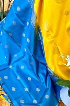 This stunning borderless kanjivaram silk saree in turmeric yellow is handwoven. The simple pallu is in teal blue color. The body is adorned with rangoli/kolam motifs in different sizes in gold zari. The blouse piece is in the same color as the pallu. Approximate Length 6.5 mtrs (inclusive of blouse length)Approximate height - 44 - 50” Approximate weight - 1.3 lbs Kindly Note : The colors you see on your device may vary due to the color reproduction, brightness and resolution of individual device Blue Katan Silk Saree With Traditional Patterns, Blue Katan Silk Saree For Puja, Blue Paithani Silk Dupatta With Traditional Patterns, Blue Paithani Silk Saree With Self Design, Blue Paithani Silk Saree With Traditional Patterns, Blue Saree With Traditional Patterns For Puja, Blue Katan Silk Dupatta With Motifs, Blue Tussar Silk Saree For Diwali, Blue Handloom Katan Silk Saree