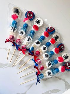 a bunch of lollipops with spiderman faces on them