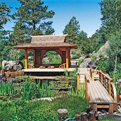 there is a small wooden bridge in the middle of this park with lots of trees