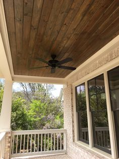 a ceiling fan on the outside of a porch