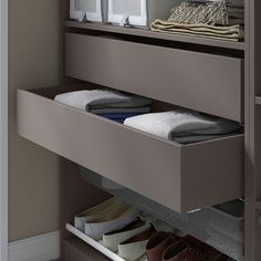 an open drawer in a closet with shoes and other items on the shelf below it