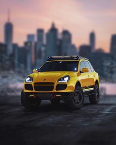 a yellow suv is parked in front of a cityscape