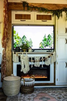 a living room with a fire place and potted plants in front of the window