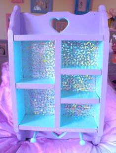 a purple and blue toy shelf with glitter on it