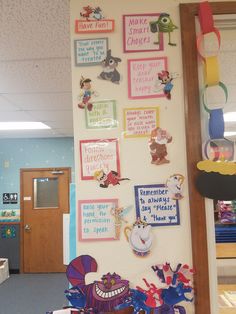 a bulletin board with pictures and magnets on it in an office cubicle area