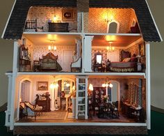 a doll house with all the furniture and accessories in it's rooms lit up