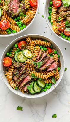 three bowls filled with pasta, meat and vegetables