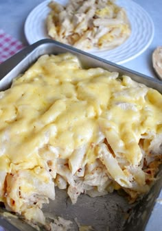 a casserole dish with chicken and cheese on top