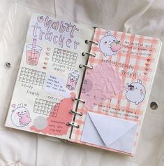 an open planner book with stickers on it