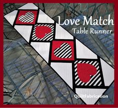 the cover of love match table runner, with red hearts on white and black squares