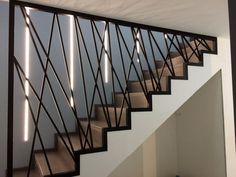 a stair case that has some lights on the side of it and is next to a wall