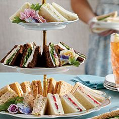 three tiered plates with sandwiches and drinks on them