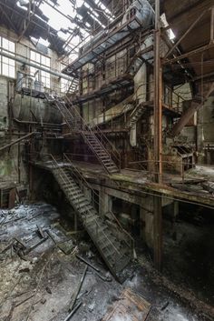 an abandoned building with lots of stairs and windows