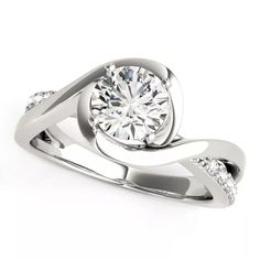 a white gold engagement ring with diamonds on the band and a center stone in the middle