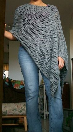 a woman wearing a gray knitted shawl