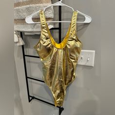 New Without Tags. Size Medium. **All Sales Final. I Try My Best To List Any Imperfection On Every Listing As Accurately As Possible If There Are Any. All Clothes Are Used Unless Specified As New. If Any Questions, Please Ask Before Purchasing.** Gold Stretch Bodysuit For Summer, Gold Stretch Sleeveless Bodysuit, Gold Sleeveless Bodysuit For Night Out, Fitted Gold Bodysuit For Beach, Gold Fitted Sleeveless Swimwear, Fitted Gold Sleeveless Swimwear, Fitted Sleeveless Gold Swimwear, Metallic Bodysuit, Bodysuit Costume