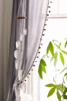 a wind chime hanging in front of a window