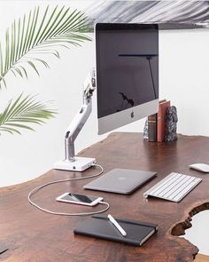 a wooden desk with a computer monitor, keyboard and mouse