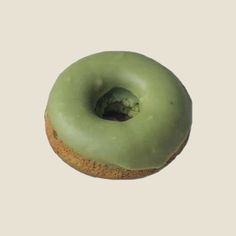 a doughnut with green icing on a white background