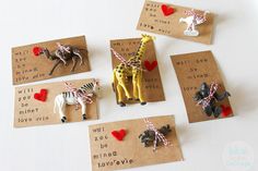 some little giraffes and zebras are on brown cards with red hearts