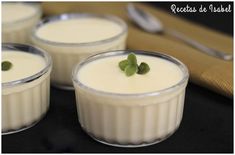 three small glasses filled with pudding on top of a table