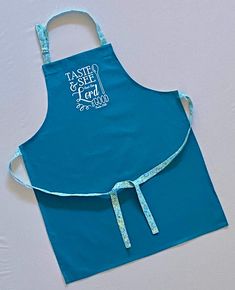 a blue apron with the words taste and see on it