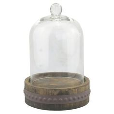 a wooden base with a glass dome on top