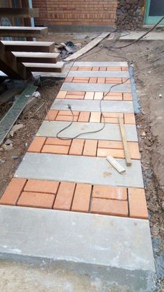 a brick walkway being built in front of a house