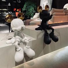 a couple of cartoon figures sitting on top of a white counter next to each other