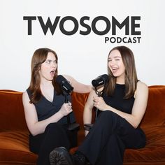 two women sitting on a couch with hair dryers in their hands and one holding a microphone