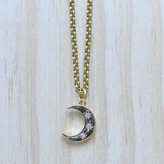 This necklace is made from a gold plated pendant. The charm is in the shape of a crescent moon. The front of the crescent moon has three stars with clear cz crystals. The necklace is finished off with a gold plated stainless steel chain. You can choose the style and length of the chain. Please choose the length you would like the necklace in. Please choose the chain style you would like your pendant on. Please note that all necklaces are handmade and may differ from the pictured. The picture sho Celestial Metal Necklace With Moon Charm, Celestial Crescent Moon Phase Necklace, Gold Crescent Celestial Necklace, Celestial Crescent Gold Necklace, Spiritual Crescent Moon Phase Charm Necklace, Celestial Crescent Charm Necklaces With Adjustable Chain, Moon Shaped Brass Necklace With Moon Charm, Celestial Crescent Necklace With Adjustable Chain, Brass Moon-shaped Necklace With Moon Charm