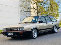 an old station wagon parked in front of a building