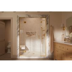 a bathroom with a walk in shower sitting next to a sink and a mirror on the wall