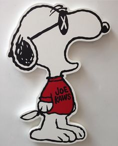 a sticker depicting a snoopy dog wearing a red shirt with the words joe kaws written on it