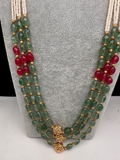 Emerald Ruby Pearls Nakshi Multi Layer Necklace Only Neckalce no earringsColor : GoldenSize : Necklace Length : 22 Inches Approx;Stones : Pearl Real Emeralds Nakshi Balls