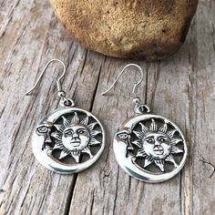 "Sun and Moon  Silvertone Earrings One of our most popular pendants now in earrings! Round sun face and moon face charm earrings Nice size- 1\" pendant which dangles about 1 3/4\" from the ear. Shiny silvertone zinc alloy with slight antique finish. Surgical steel ear wires. And we have a necklace to match!  Search sunmoon or sun moon in our shop! Your earrings will come in an organza bag to gift or keep for yourself. Bubble wrapped for safe travel. To view a personalized sun necklace click here Symbolic Dangle Earrings With Sun And Moon Design, Symbolic Sun And Moon Dangle Earrings, Silver Sun And Moon Drop Earrings, Silver Sun And Moon Design Drop Earrings, Silver Earrings With Sun And Moon Design - Symbolic, Silver Symbolic Earrings With Sun And Moon Design, Symbolic Silver Earrings With Sun And Moon Design, Sun Moon Earrings, Earrings Moon