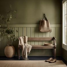 a wooden bench sitting next to a potted plant