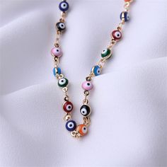 Bring colorful shine to your look with this necklace showcasing multi-hued Evil Eye beads. 13.39'' L with 1.97'' extender Lobster claw clasp Goldtone copper / enamel Multicolor Round Jewelry With Lobster Clasp, Colorful Jewelry With Adjustable Chain, Multicolor Round Jewelry With Adjustable Chain, Colorful Necklace With Adjustable Chain As Gift, Multicolor Dangle Jewelry With Lobster Clasp, Multicolor Metal Necklace With Adjustable Chain, Adjustable Multicolor Metal Chain Necklace, Multicolor Gold Plated Dangle Jewelry, Multicolor Round Evil Eye Jewelry