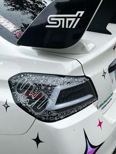 the front end of a car with stickers on it