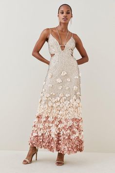 As Pretty As A Picture, This Flowing Maxi Dress Boasts Gleaming Crystal Embellishments And A Cascade Of Applique Petals Dotting The Skirt. Two Sets Of Ultra-Slim Straps Frame The Neckline, Accentuating Edgy Side Cut-Outs And An Open Back. Anchor The Feminine Palette And Elegant Embellishments With Dramatic Drop Earrings And Slicked-Back Hair. Feminine Palette, Closet Necessities, Hen Do Outfits, Hen Party Dress, Hen Party Outfits, Latest Maxi Dresses, Maxi Dress Designs, Dress With Flowers, Maxi Dress Collection