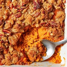 a casserole dish filled with sweet potatoes and pecans