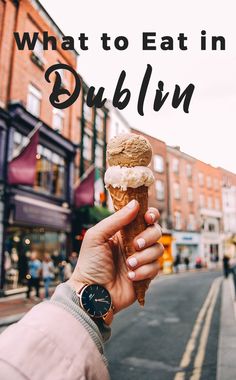 a person holding up an ice cream cone with the words what to eat in dublin