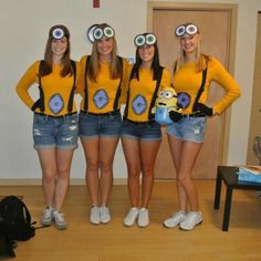 three girls in yellow shirts and blue shorts are standing with their hands on their hips